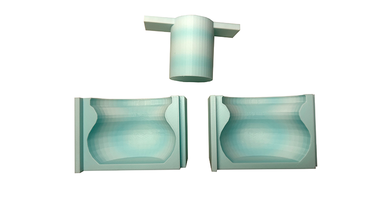 Dreiteilige, 3D-gedruckte Gießform für einen bauchigen Kerzenhalter, bestehend aus zwei Formhälften und einem zylindrischen Einsatz.
